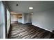 Bright open-concept living room with luxury vinyl plank flooring and access to the kitchen at 500 Kings Pl, Riverdale, GA 30296