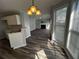 Open living space featuring hardwood flooring, modern lighting, and a cozy fireplace at 500 Kings Pl, Riverdale, GA 30296