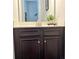 Bathroom vanity with dark brown cabinets, white countertop, and stainless steel faucet at 614 Harrington Hls, Decatur, GA 30032