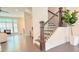 Bright living room with hardwood floors and stairs with wood and metal banisters at 614 Harrington Hls, Decatur, GA 30032