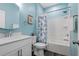 Light blue bathroom with a shower/tub combo and a white vanity sink at 1098 Caruso Dr, Buford, GA 30518
