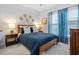 Comfortable bedroom with blue bedding, wood furniture, and natural light at 1098 Caruso Dr, Buford, GA 30518