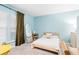 Cozy bedroom with blue walls, natural light from the window, and simple decor creating a serene atmosphere at 1098 Caruso Dr, Buford, GA 30518