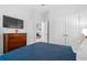 Cozy bedroom features a dresser, TV, and a view into the hallway at 1098 Caruso Dr, Buford, GA 30518