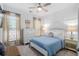 Bedroom featuring light walls, a bed with a blue coverlet, and neutral-toned curtains at 1098 Caruso Dr, Buford, GA 30518