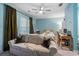 Carpeted bedroom with a sofa, desk, and bed, illuminated by natural light at 1098 Caruso Dr, Buford, GA 30518