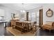 Bright dining room featuring a wooden table, chandelier, large windows, and modern decor at 1098 Caruso Dr, Buford, GA 30518