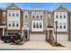 Beautiful townhome with brick and siding, a covered front porch, and an attached garage at 1098 Caruso Dr, Buford, GA 30518