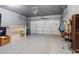 Spacious garage with an epoxy floor, a white door, and ample storage space for vehicles and equipment at 1098 Caruso Dr, Buford, GA 30518