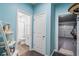 Hallway view featuring a bathroom door and garage entrance with a clean, minimalist design and cool-toned walls at 1098 Caruso Dr, Buford, GA 30518