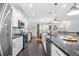 Modern kitchen with white cabinets, granite counters, stainless appliances, open to dining area at 1098 Caruso Dr, Buford, GA 30518