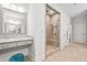 Bright bathroom vanity with granite countertop, vanity with makeup space, and glass-enclosed shower at 1112 Cordia Nw Ave, Atlanta, GA 30318