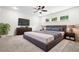 Comfortable bedroom featuring a large bed, ceiling fan, and serene natural light from the windows at 1112 Cordia Nw Ave, Atlanta, GA 30318
