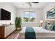 This bedroom offers a cozy space with natural light, wood floors, and stylish modern decor at 1112 Cordia Nw Ave, Atlanta, GA 30318