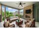 Relaxing covered patio with brick fireplace, TV, ceiling fan, and comfortable seating for outdoor enjoyment at 1112 Cordia Nw Ave, Atlanta, GA 30318