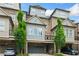 Charming townhome showcases a grey exterior with brick accents, a private garage, and manicured landscaping at 1112 Cordia Nw Ave, Atlanta, GA 30318