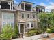 Charming townhome with stone facade, bay window, and inviting balconies offering stylish outdoor living spaces at 1112 Cordia Nw Ave, Atlanta, GA 30318