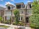Charming townhome featuring stone and brick accents, covered entryways, and well-manicured landscaping at 1112 Cordia Nw Ave, Atlanta, GA 30318