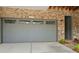 Attached garage with neutral door and brick exterior at 1112 Cordia Nw Ave, Atlanta, GA 30318