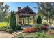 Community gazebo featuring a stone fireplace, seating, and beautiful landscaping at 1112 Cordia Nw Ave, Atlanta, GA 30318