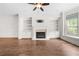 Bright living room with a fireplace, built-in shelving, and a large window with natural light at 1112 Cordia Nw Ave, Atlanta, GA 30318