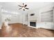 Spacious living room featuring a fireplace, built-in bookshelves, and hardwood floors at 1112 Cordia Nw Ave, Atlanta, GA 30318