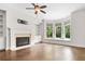 Cozy living room with hardwood floors, a fireplace, built-ins, and a bay window at 1112 Cordia Nw Ave, Atlanta, GA 30318