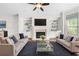 Inviting living room featuring a fireplace, built-in shelves, comfortable seating, and large windows for natural light at 1112 Cordia Nw Ave, Atlanta, GA 30318