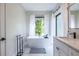 Bright bathroom featuring a modern soaking tub by a large window with natural light at 240 Patterson Se Ave, Atlanta, GA 30316