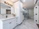 A bathroom featuring white cabinets, a sleek shower, and luxurious marble flooring, creating a spa-like ambiance at 240 Patterson Se Ave, Atlanta, GA 30316