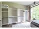 An organized walk-in closet showcasing ample shelving and storage solutions, enhanced by a large window at 240 Patterson Se Ave, Atlanta, GA 30316