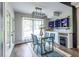Bright dining room with modern glass table, blue chairs, and unique built-in shelving at 240 Patterson Se Ave, Atlanta, GA 30316