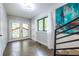 Bright foyer with stained glass doors, staircase, and modern artwork at 240 Patterson Se Ave, Atlanta, GA 30316