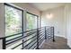 Bright hallway with metal railing and large windows showcasing a view of the outdoors at 240 Patterson Se Ave, Atlanta, GA 30316