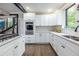 Modern kitchen with stainless steel oven, sleek white cabinetry, and wood flooring at 240 Patterson Se Ave, Atlanta, GA 30316