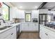 Bright kitchen features white cabinets, stainless steel appliances, and a window overlooking greenery at 240 Patterson Se Ave, Atlanta, GA 30316