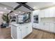 Open kitchen layout with an island cooktop, white cabinetry, and a view to the living area at 240 Patterson Se Ave, Atlanta, GA 30316