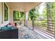 Cozy covered patio with comfortable seating and view of lush landscaping and stylish outdoor rug at 240 Patterson Se Ave, Atlanta, GA 30316