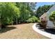 Lush backyard featuring green grass, shaded trees, and a stone pathway, perfect for relaxing at 2735 Princeton Trce, Cumming, GA 30041