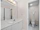 Bright bathroom featuring a white vanity, large mirror, and a toilet in the room at 2735 Princeton Trce, Cumming, GA 30041