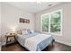 Cozy bedroom with a large window offering a picturesque view and hardwood flooring at 2735 Princeton Trce, Cumming, GA 30041