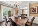 Formal dining room with a large wooden table, chairs, and a window providing natural light at 2735 Princeton Trce, Cumming, GA 30041