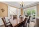 Formal dining room with a large wooden table, chairs, and a window providing natural light at 2735 Princeton Trce, Cumming, GA 30041