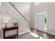 Foyer with hardwood floors, staircase, neutral paint, and a bright white front door at 2735 Princeton Trce, Cumming, GA 30041
