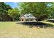 Charming two-story home with manicured lawn, brick facade, black shutters, and inviting front porch under tree at 2735 Princeton Trce, Cumming, GA 30041