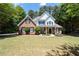 Charming two-story home with a manicured lawn, brick facade, black shutters, and inviting front porch at 2735 Princeton Trce, Cumming, GA 30041