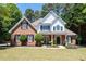 Charming two-story home with a manicured lawn, brick facade, black shutters, and inviting front porch at 2735 Princeton Trce, Cumming, GA 30041