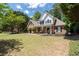 Charming two-story home with a manicured lawn, brick facade, black shutters, and inviting front porch at 2735 Princeton Trce, Cumming, GA 30041