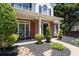 Inviting front porch with rocking chairs, manicured landscaping, and a classic black front door at 2735 Princeton Trce, Cumming, GA 30041