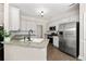 Modern kitchen with stainless steel appliances, granite countertops, and ample cabinet space at 2735 Princeton Trce, Cumming, GA 30041